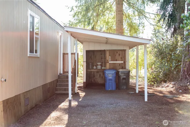 a view of a porch with furniture and a yard