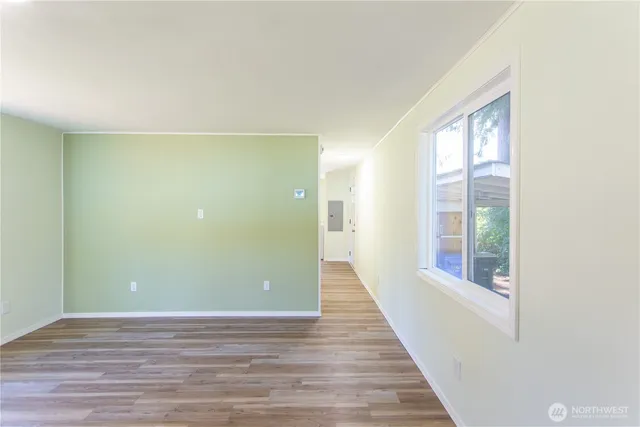 a view of a room with wooden floor and windows