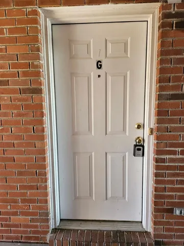 a view of a door with brick walls