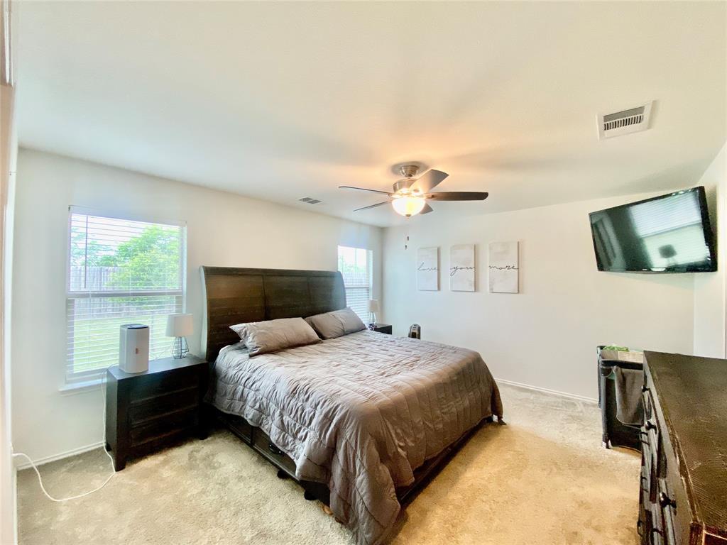 110 West Point Way Elgin, TX 78621 - Photo 8 of 19 Natural light fills a relaxing bedroom with soft carpeting.