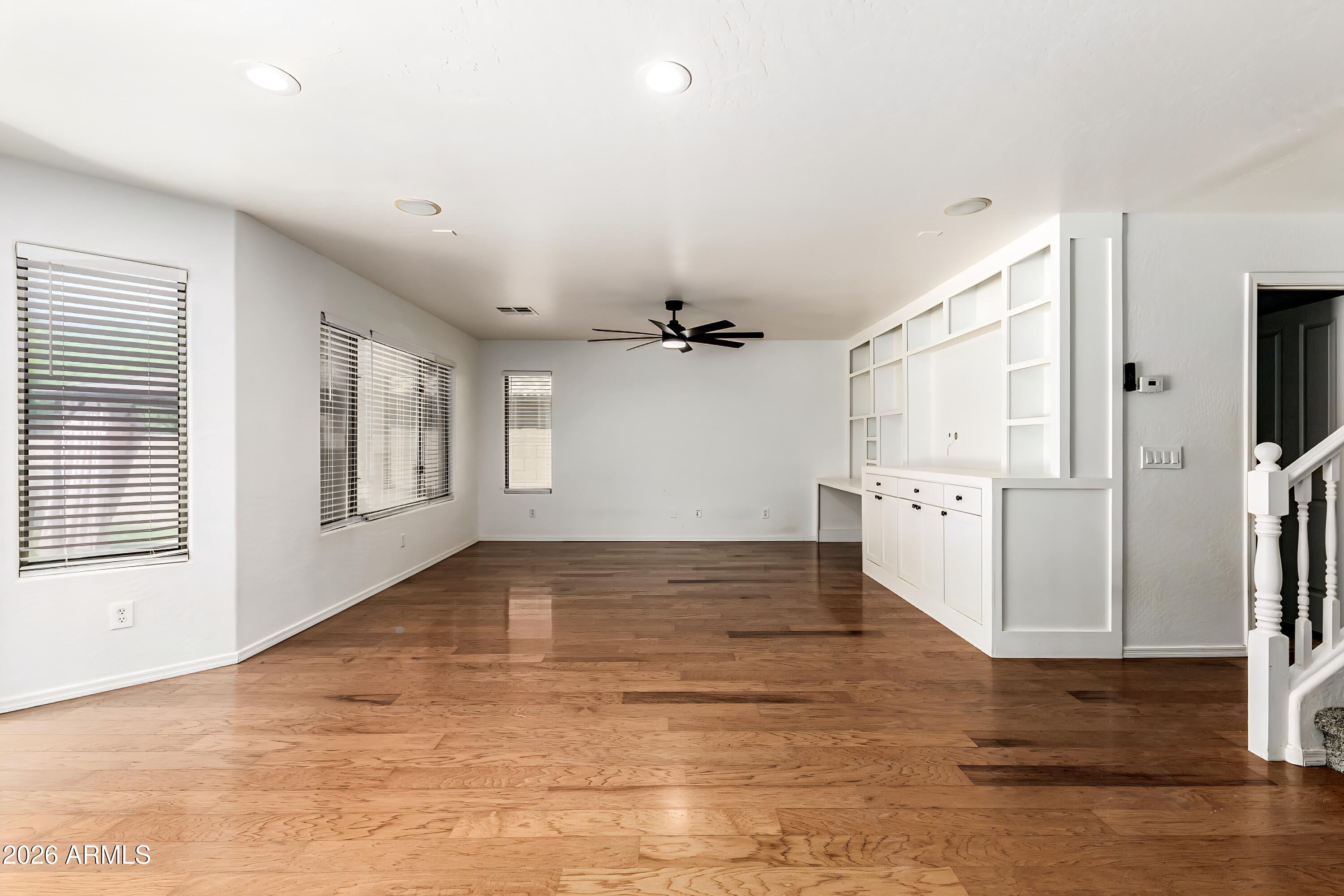 4208 South Sawmill Road Gilbert, AZ 85297 - Photo 8 of 46 a view of empty room with wooden floor and fan