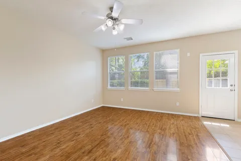 wooden floor in an empty room with a window