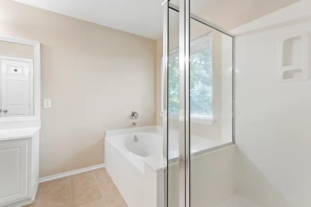 a bathroom with a bathtub and a shower
