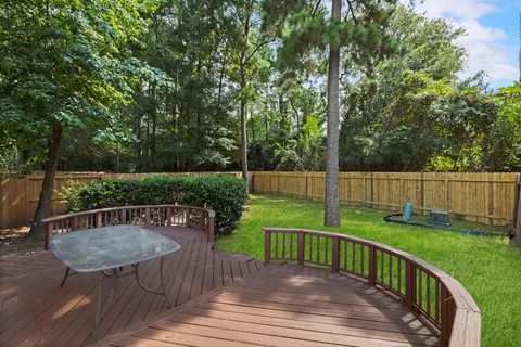 a view of a deck with chair and garden