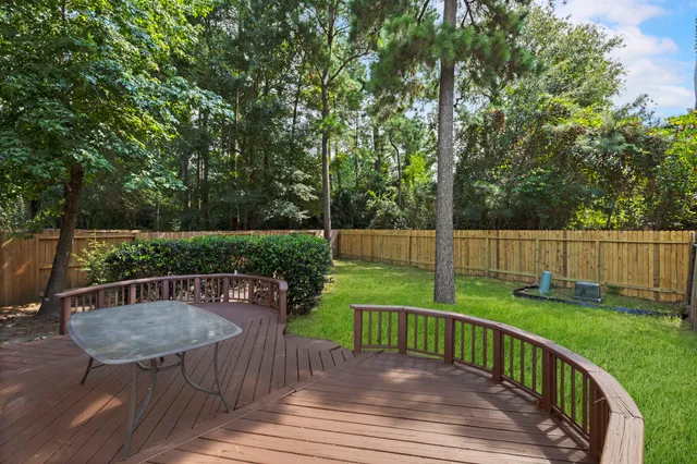 a view of a deck with chair and garden
