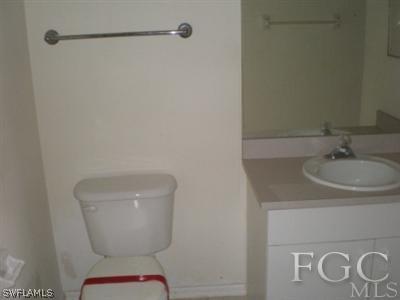 808 Rue Labeau Circle Fort Myers, FL 33913 - Photo 7 of 9 a bathroom with a toilet sink and mirror