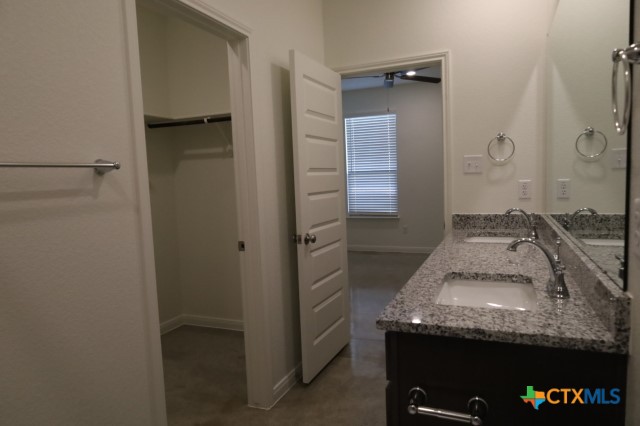 2916 Wildcat Rdg Road, Unit B Temple, TX 76501 - Photo 13 of 39 a bathroom with a granite countertop sink and washing machine