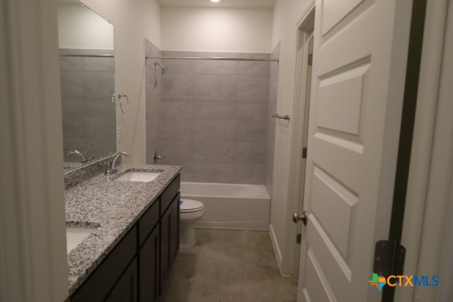 2916 Wildcat Rdg Road, Unit B Temple, TX 76501 - Photo 14 of 39 a bathroom with a granite countertop sink and a mirror