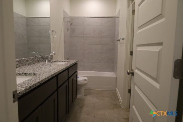 2916 Wildcat Rdg Road, Unit B Temple, TX 76501 - Photo 15 of 39 a bathroom with a granite countertop sink and a mirror