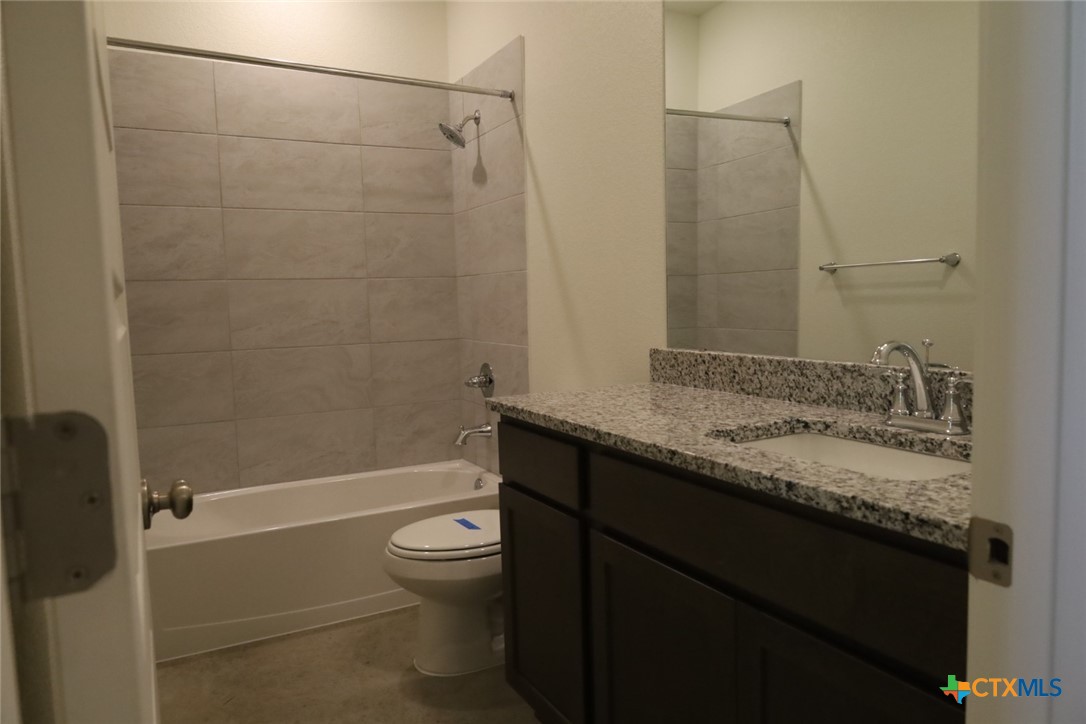 2916 Wildcat Rdg Road, Unit B Temple, TX 76501 - Photo 27 of 39 a bathroom with a granite countertop sink toilet and shower