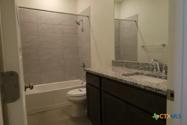 a view of an empty room and hallway with wooden floor