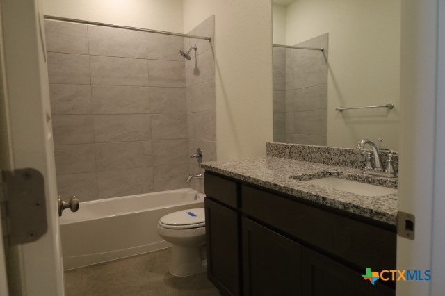 2916 Wildcat Rdg Road, Unit B Temple, TX 76501 - Photo 30 of 39 a bathroom with a granite countertop sink toilet and shower