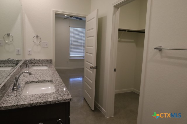 2916 Wildcat Rdg Road, Unit B Temple, TX 76501 - Photo 36 of 39 a bathroom with a granite countertop sink and a mirror