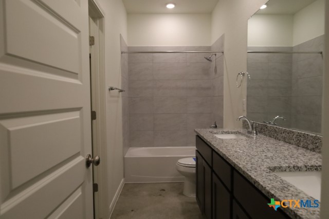 2916 Wildcat Rdg Road, Unit B Temple, TX 76501 - Photo 37 of 39 a bathroom with a granite countertop sink toilet and shower