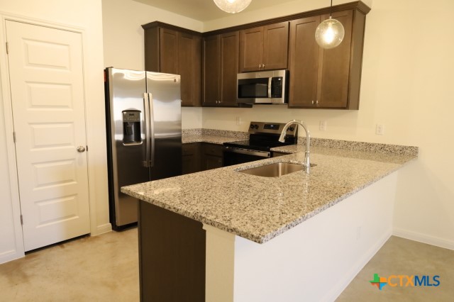 2916 Wildcat Rdg Road, Unit B Temple, TX 76501 - Photo 6 of 39 a kitchen with stainless steel appliances granite countertop a sink stove and refrigerator