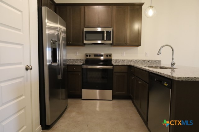 2916 Wildcat Rdg Road, Unit B Temple, TX 76501 - Photo 7 of 39 a kitchen with stainless steel appliances granite countertop a refrigerator and a sink