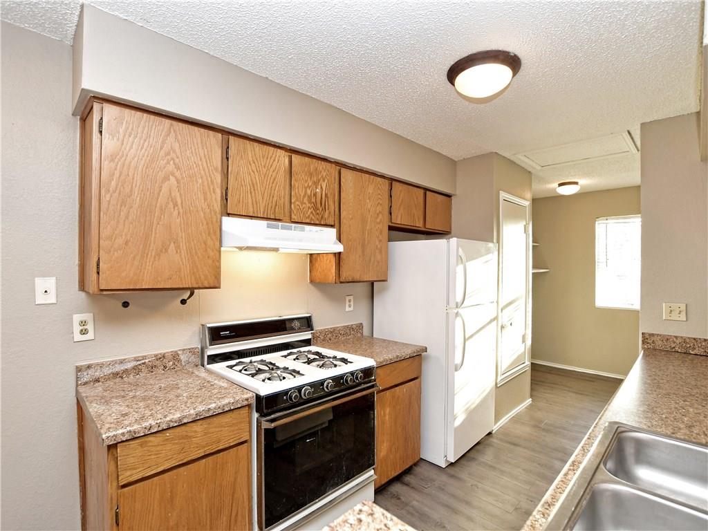 5401 Spring Meadow Road, Unit B Austin, TX 78744 - Photo 8 of 21 Functional kitchen with ample cabinet space and modern appliances for everyday living.