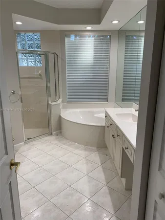 a bathroom with a glass shower door
