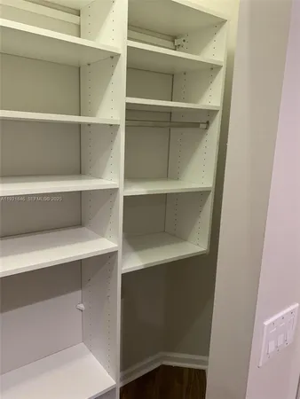 a bathroom with a granite countertop bathtub shower and toilet