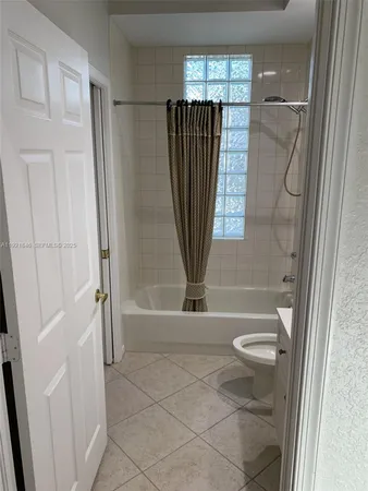 a kitchen with a sink a stove and cabinets