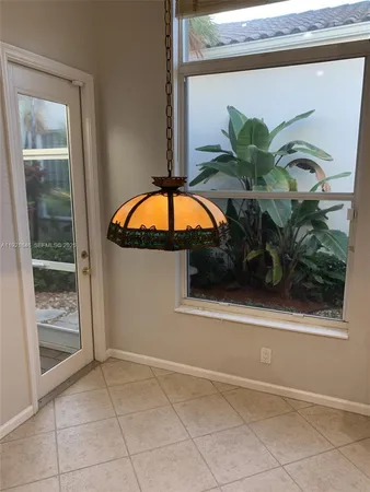 a view of a hallway with wooden floor and entryway