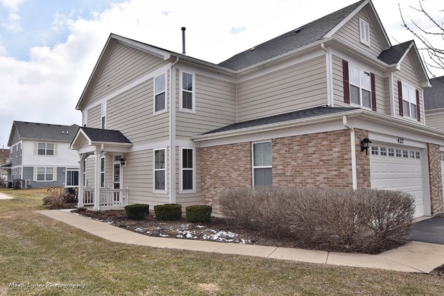 427 Acushnet Street Elgin, IL 60124 - Photo 2 of 26 a view of a white house next to a road