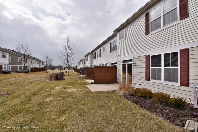 427 Acushnet Street Elgin, IL 60124 - Photo 24 of 26 a front view of a house with a yard