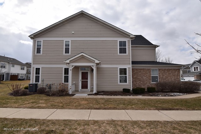 427 Acushnet Street Elgin, IL 60124 - Photo 3 of 26 a front view of a house with a yard