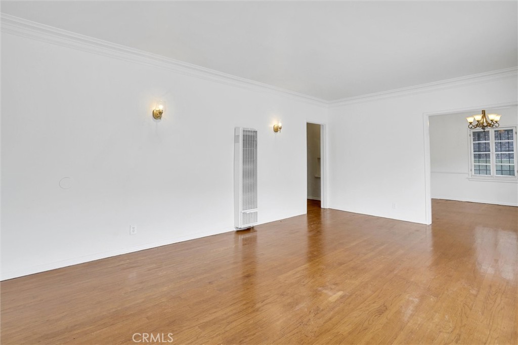515 Rose Avenue Venice, CA 90291 - Photo 14 of 49 a view of an empty room with wooden floor and a kitchen
