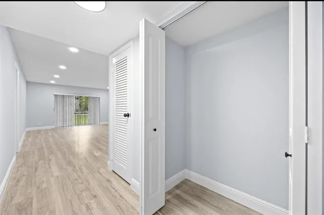 a view of hallway with wooden floor