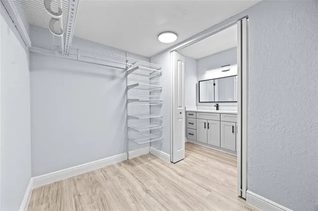 a view of empty room with cabinet and wooden floor