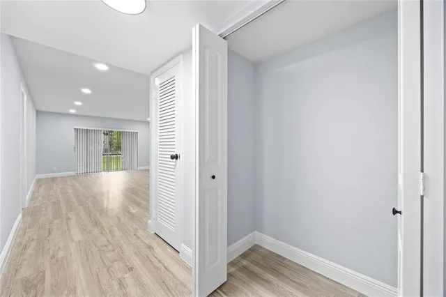 a view of hallway with wooden floor