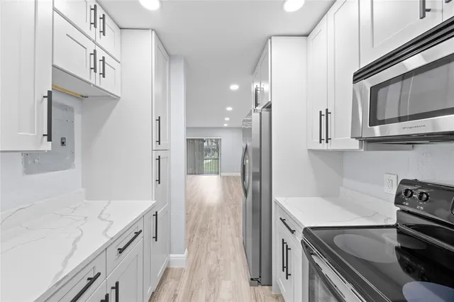 a kitchen with stainless steel appliances a stove microwave and refrigerator