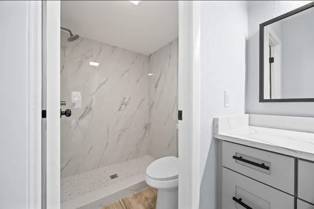 a bathroom with a sink toilet and shower