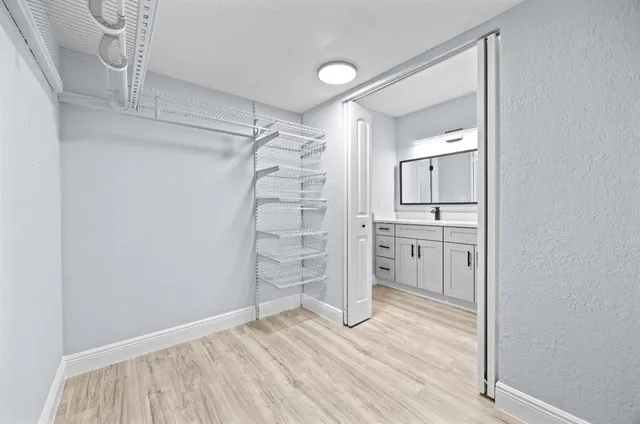 a view of empty room with wooden floor and cabinet