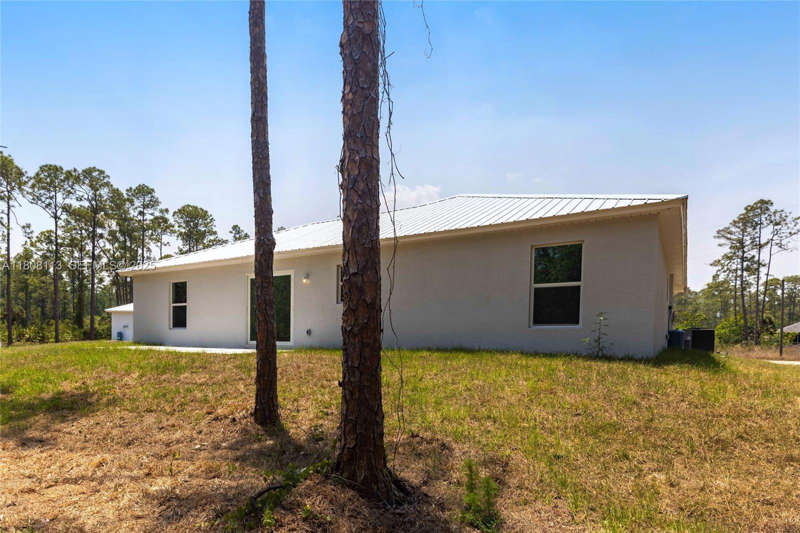 2006 Rosa Court, Unit 2006 Lehigh Acres, FL 33972 - Photo 18 of 22 a house that has a tree in front of it