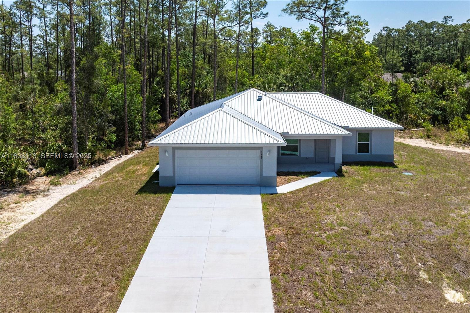 2006 Rosa Court, Unit 2006 Lehigh Acres, FL 33972 - Photo 19 of 22 a house with trees in the background