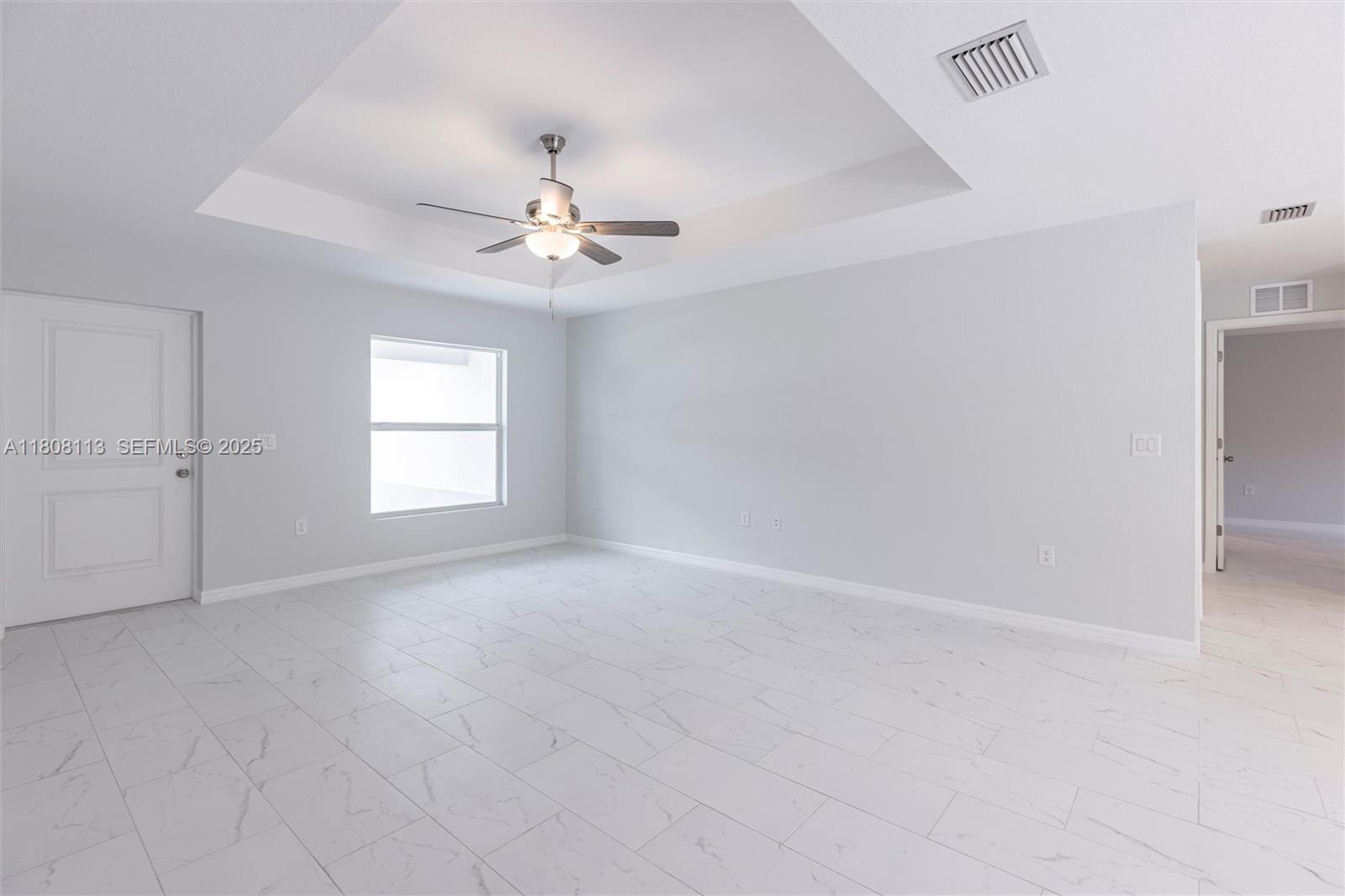 2006 Rosa Court, Unit 2006 Lehigh Acres, FL 33972 - Photo 5 of 22 wooden floor in an empty room with a window