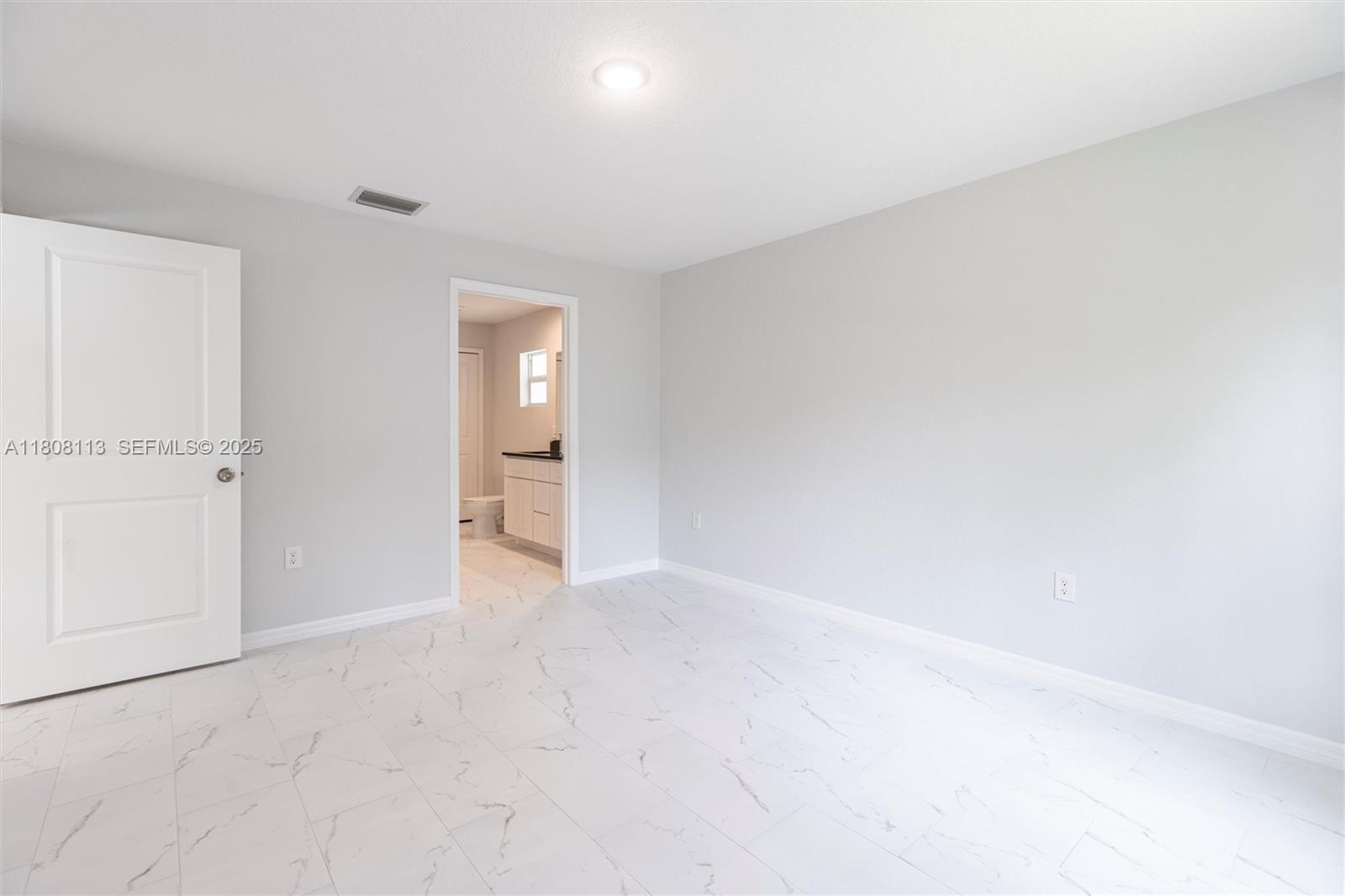 2006 Rosa Court, Unit 2006 Lehigh Acres, FL 33972 - Photo 8 of 22 wooden floor in a room and a white kitchen