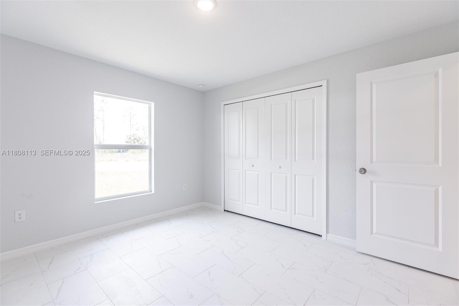 2006 Rosa Court, Unit 2006 Lehigh Acres, FL 33972 - Photo 9 of 22 an empty room with windows and closet