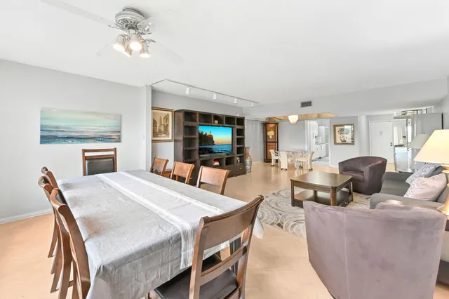 a living room with furniture a dining table and a fireplace