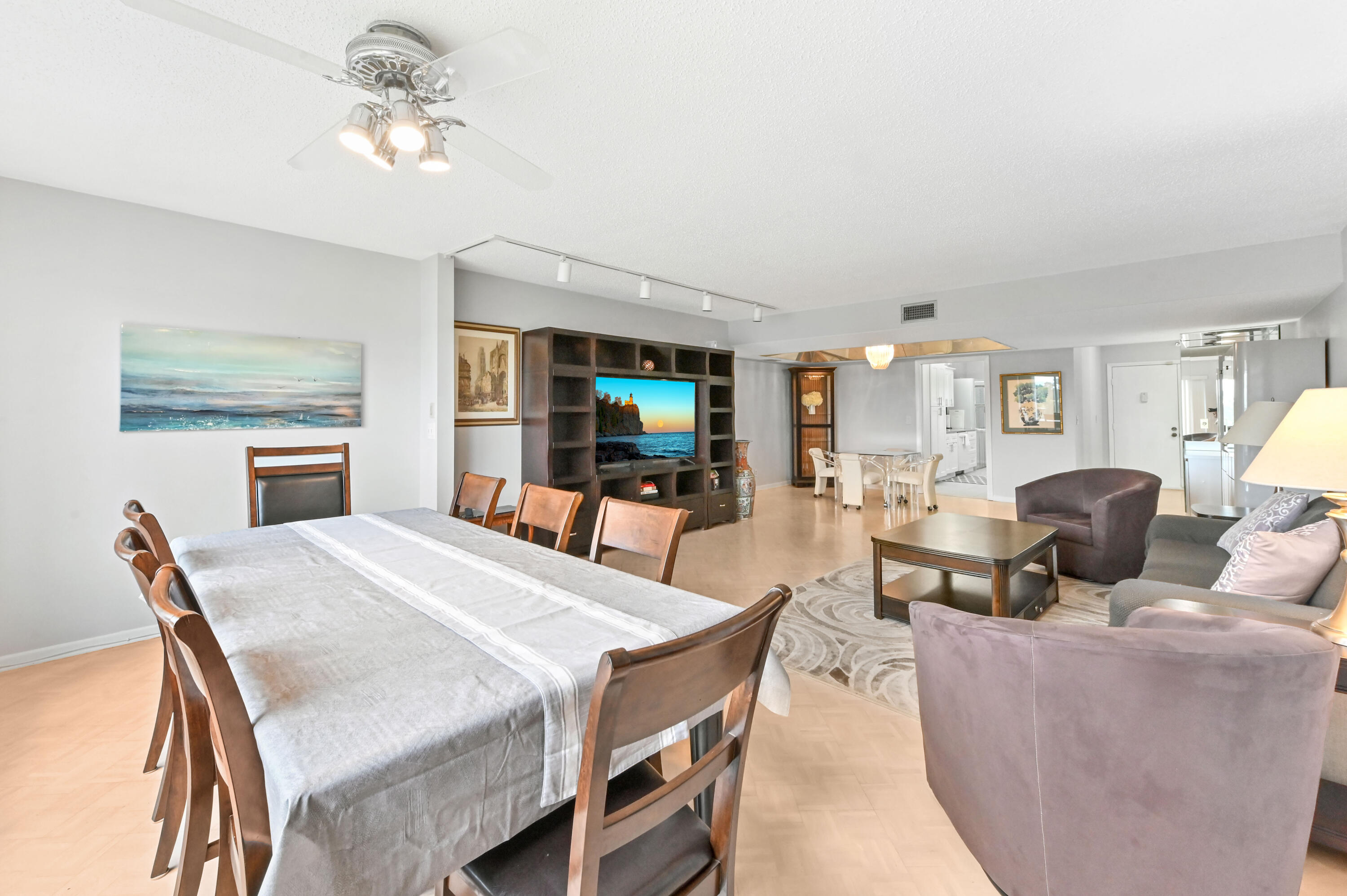 6768 10th Avenue North, Unit 316 Lake Worth, FL 33467 - Photo 14 of 38 a living room with furniture a dining table and a fireplace