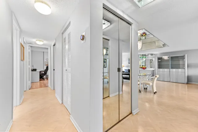 a view of a hallway with dining room and a livingroom view
