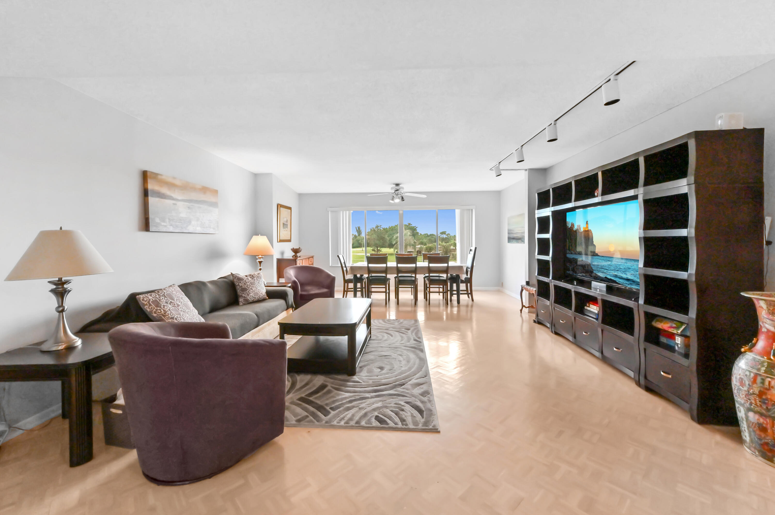 6768 10th Avenue North, Unit 316 Lake Worth, FL 33467 - Photo 2 of 38 a living room with furniture and a flat screen tv
