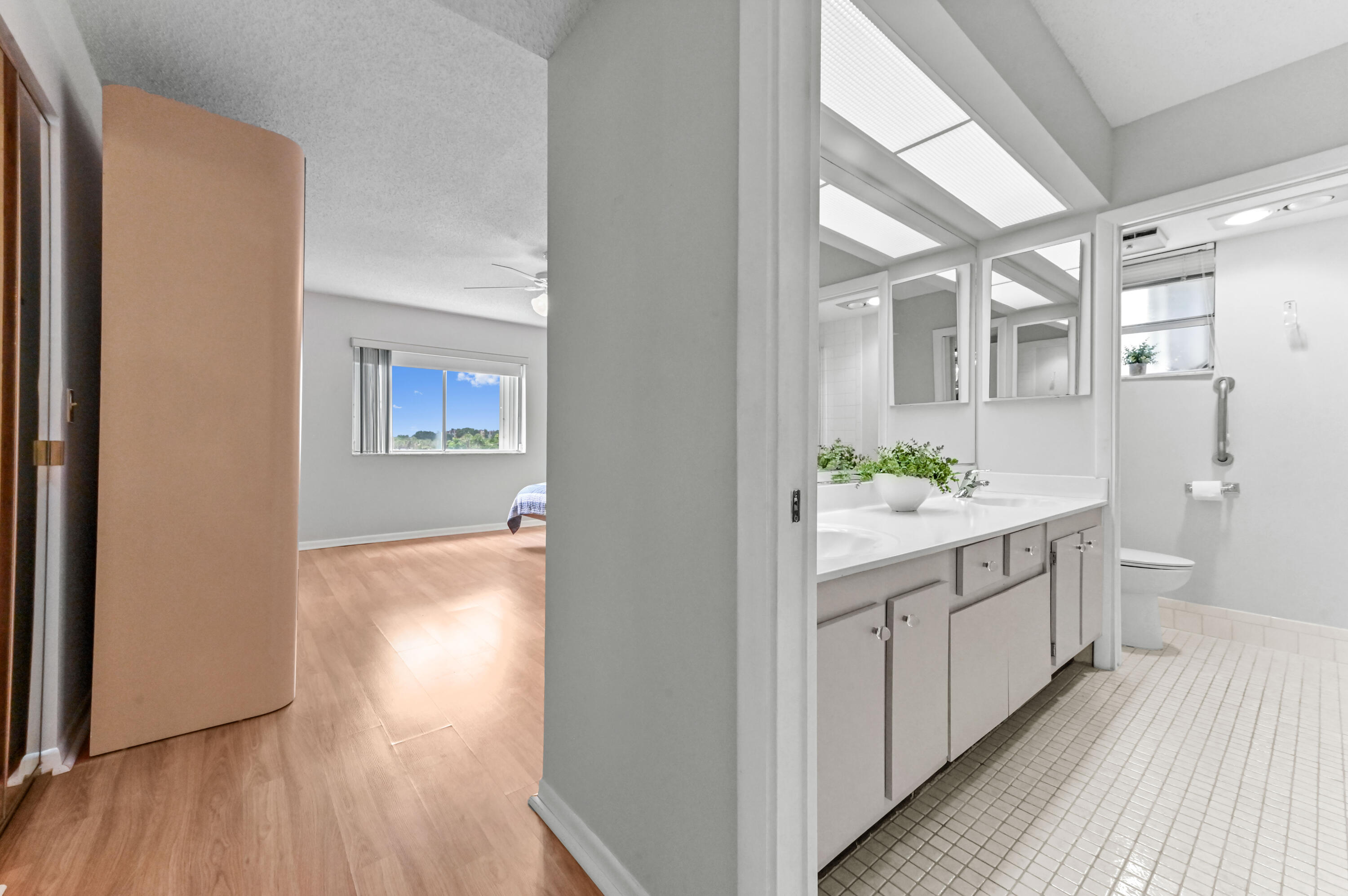 6768 10th Avenue North, Unit 316 Lake Worth, FL 33467 - Photo 23 of 38 a bathroom with a granite countertop sink and a mirror