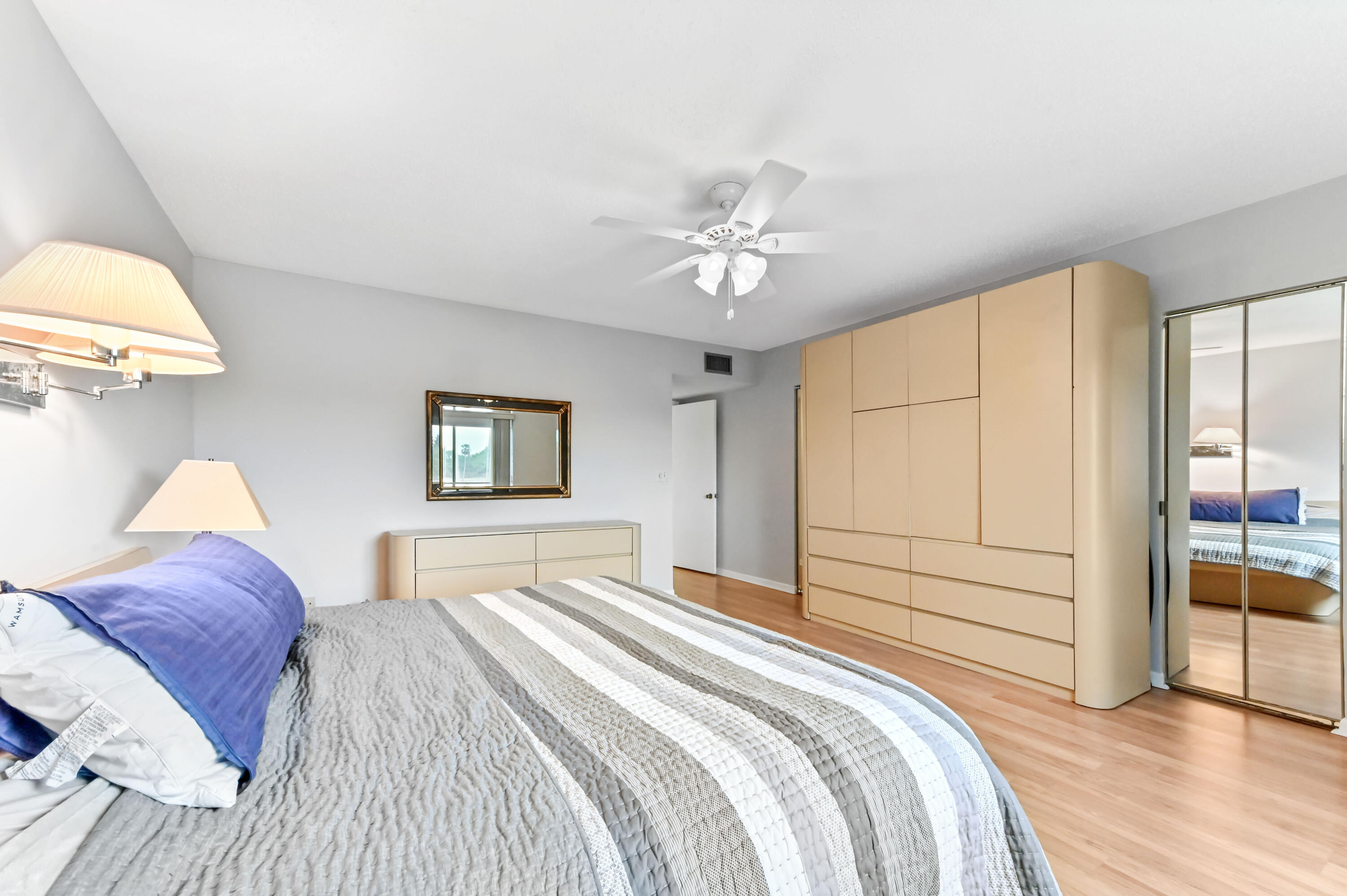 6768 10th Avenue North, Unit 316 Lake Worth, FL 33467 - Photo 25 of 38 a bedroom with a bed and a chandelier