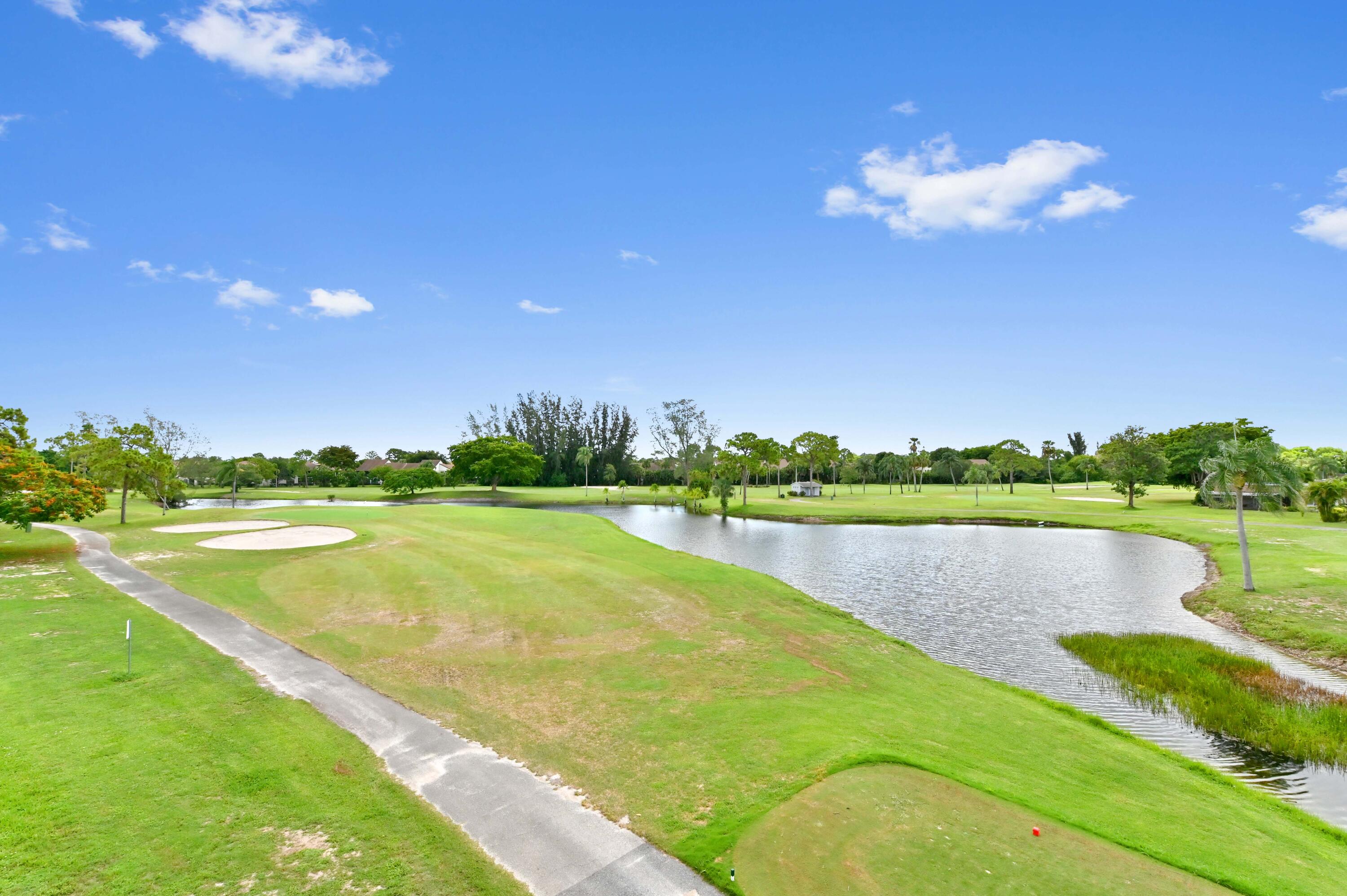 6768 10th Avenue North, Unit 316 Lake Worth, FL 33467 - Photo 32 of 38 a view of a lake with a big yard