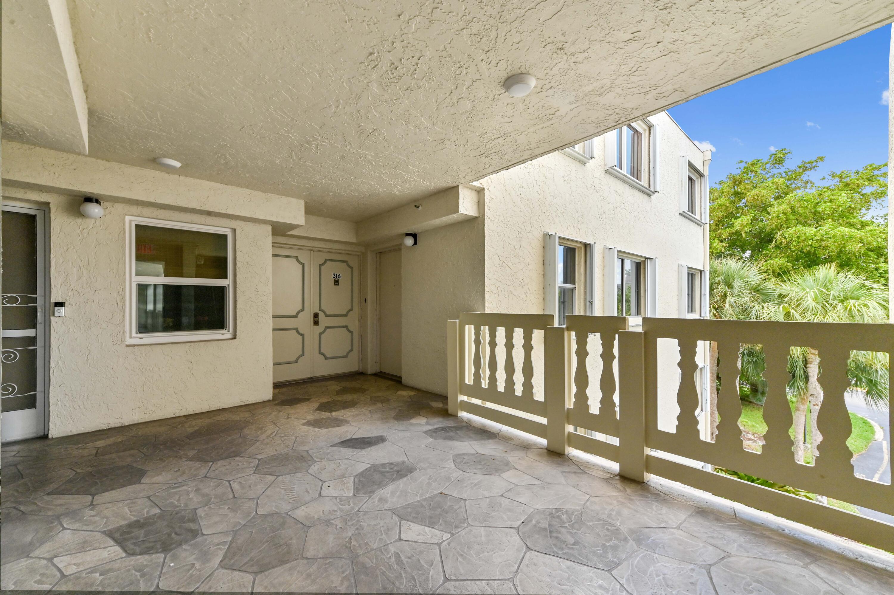 6768 10th Avenue North, Unit 316 Lake Worth, FL 33467 - Photo 36 of 38 a view of an entryway with stairs