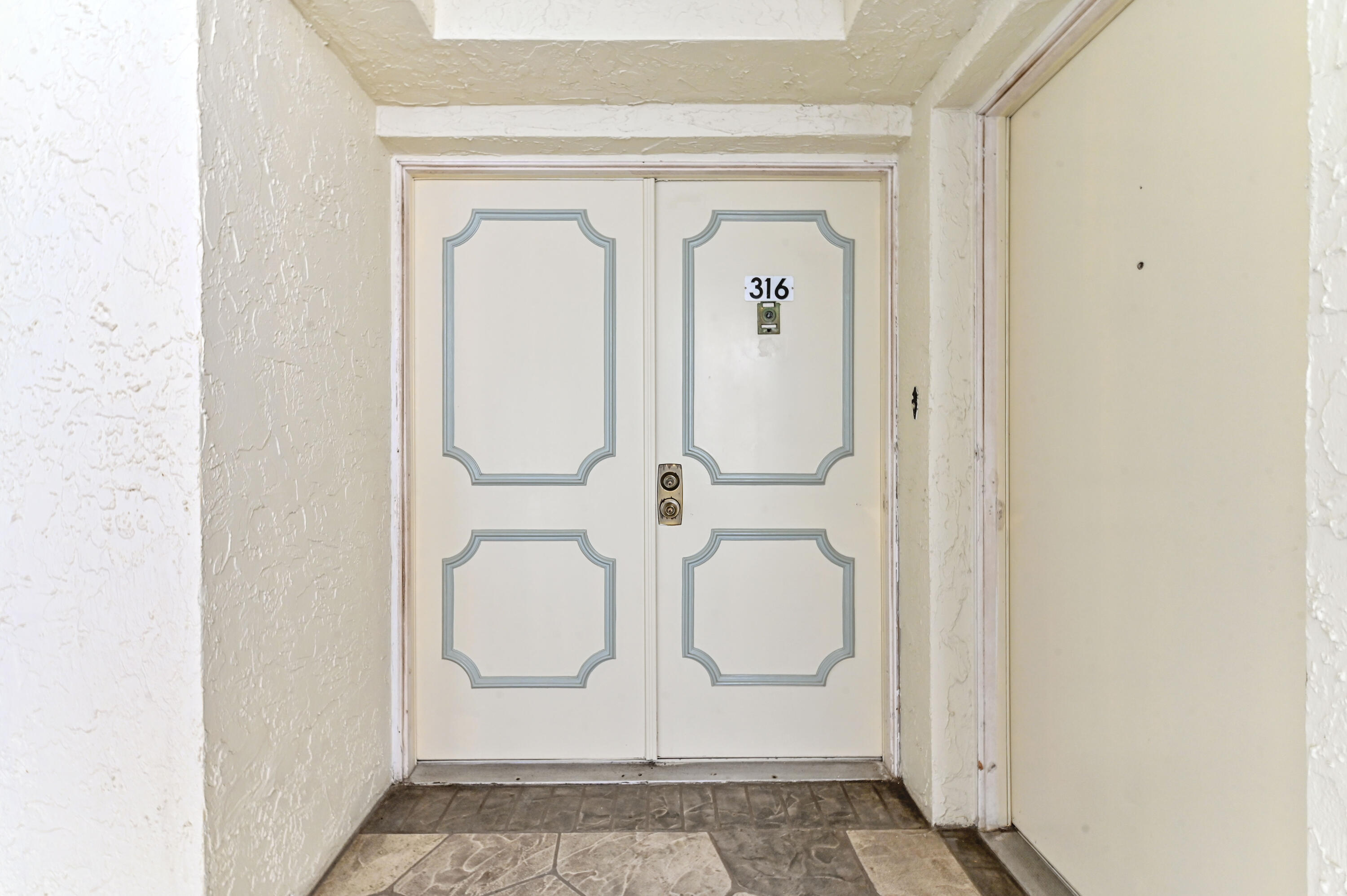 6768 10th Avenue North, Unit 316 Lake Worth, FL 33467 - Photo 37 of 38 a bathroom with a granite countertop shower