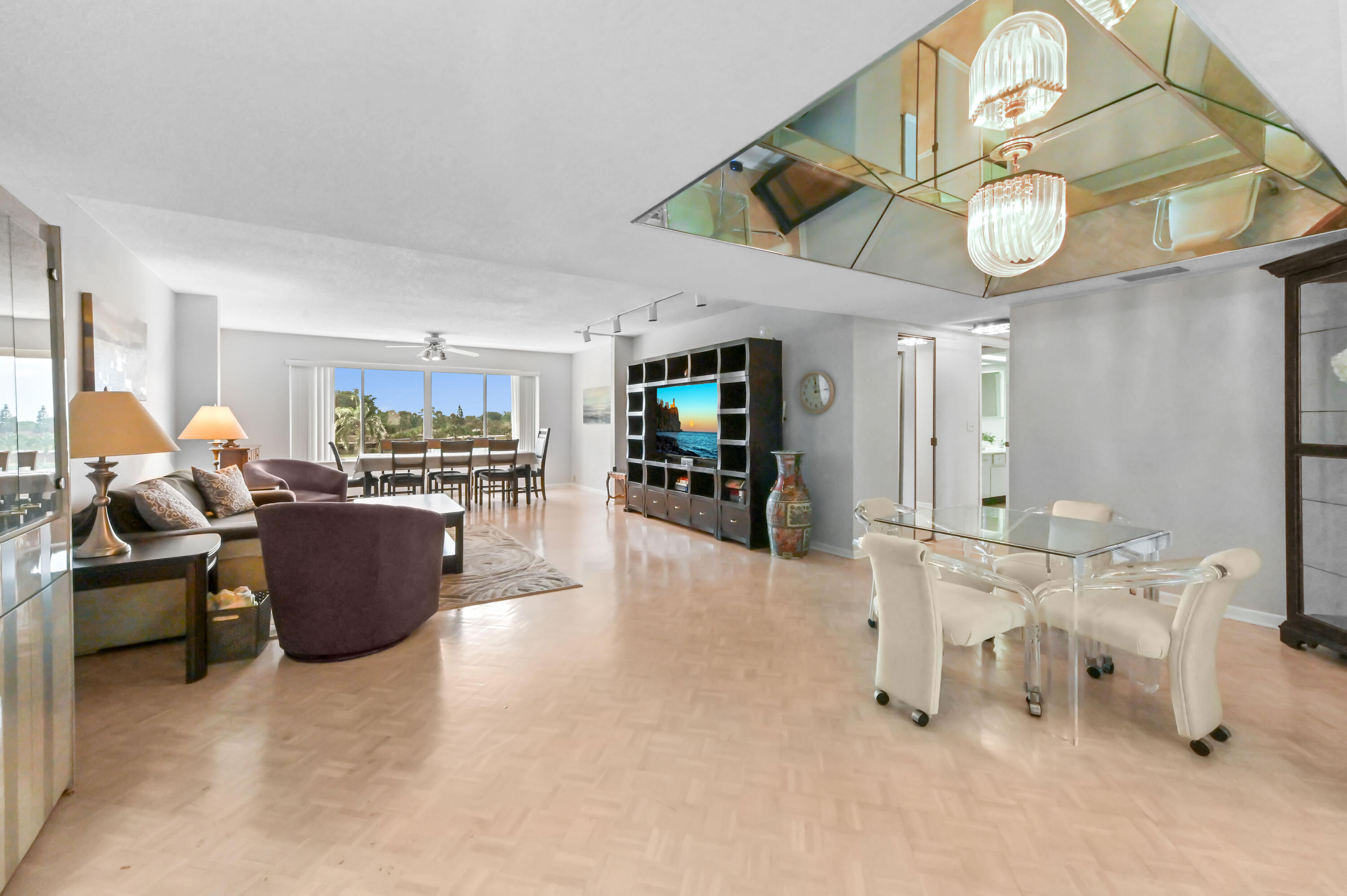 6768 10th Avenue North, Unit 316 Lake Worth, FL 33467 - Photo 6 of 38 a living room with furniture and a clock